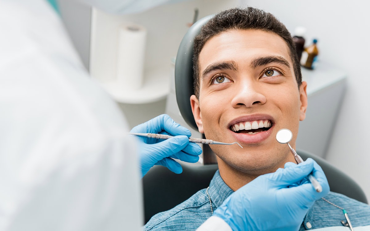 Teen Braces patient model receiving treatment in a dental chair
